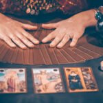 Tarot reader with tarot cards.Tarot cards face down on table nea