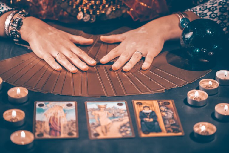 Tarot reader with tarot cards.Tarot cards face down on table nea